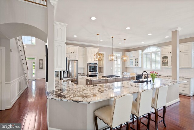 43005 Running Ridge Way, Leesburg, VA 20176 - kitchen featuring a sink, stainless steel appliances, a large island, healthy amount of natural light, and crown molding