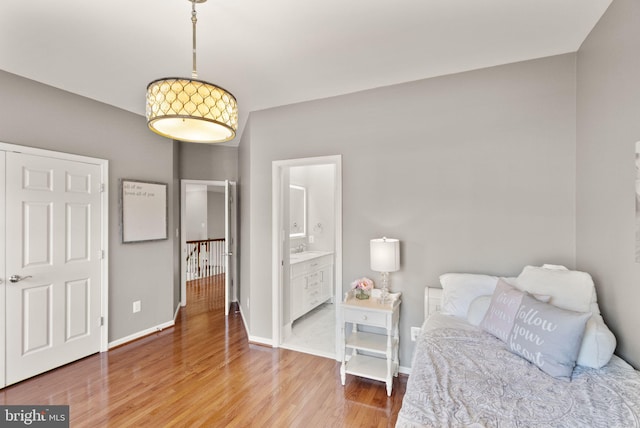 43005 Running Ridge Way, Leesburg, VA 20176 - bedroom with light wood-style flooring, baseboards, and ensuite bath