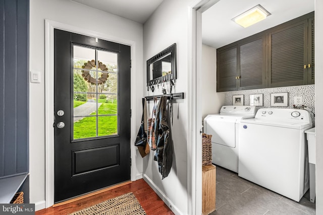 laundry room with cabinet space, washing machine and clothes dryer, tile patterned flooring, and baseboards