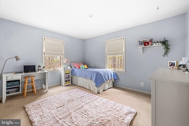 carpeted bedroom featuring multiple windows and baseboards