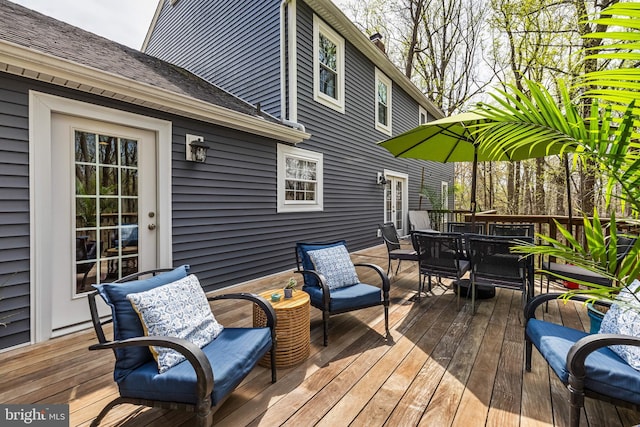 wooden terrace featuring outdoor dining space