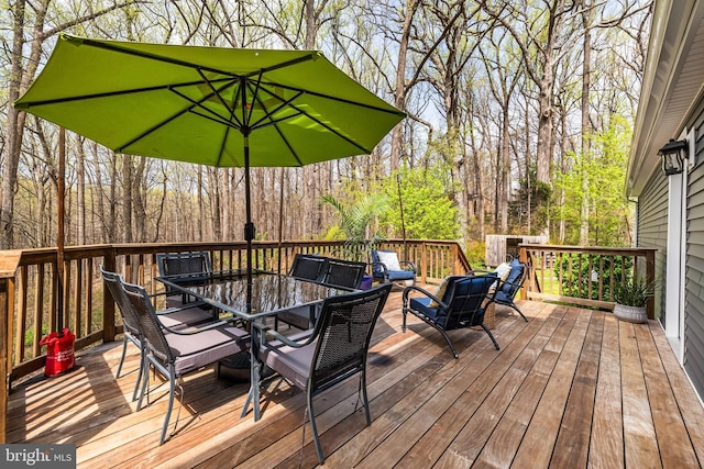 deck with outdoor dining area