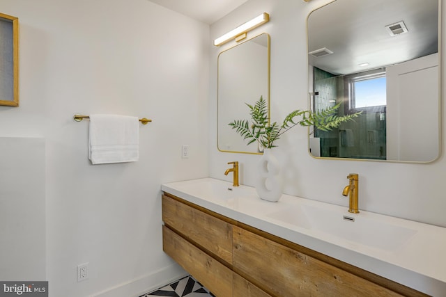 bathroom with a sink, visible vents, and double vanity