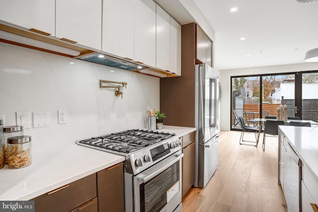 kitchen featuring light wood-style floors, light countertops, white cabinetry, and stainless steel appliances