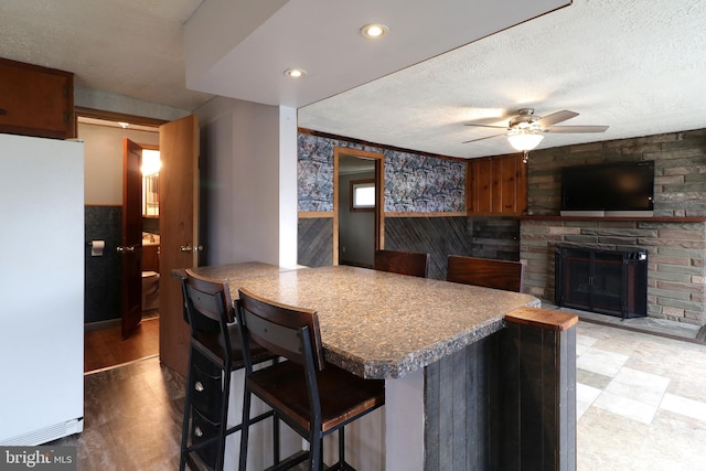 2447 General Potter Hwy, Centre Hall, PA 16828 - kitchen featuring freestanding refrigerator, a textured ceiling, ceiling fan, and wainscoting