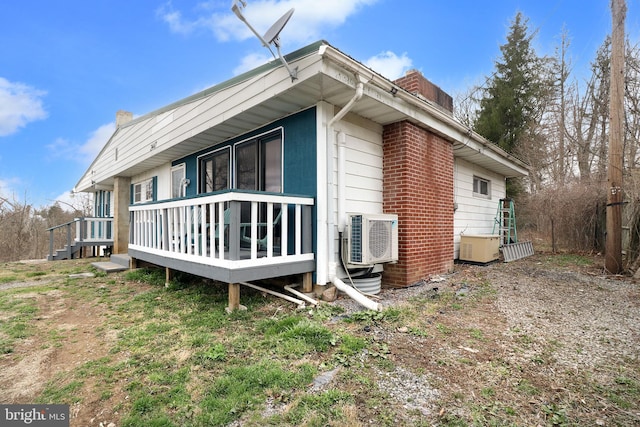 2447 General Potter Hwy, Centre Hall, PA 16828 - view of home's exterior with a chimney, ac unit, and brick siding
