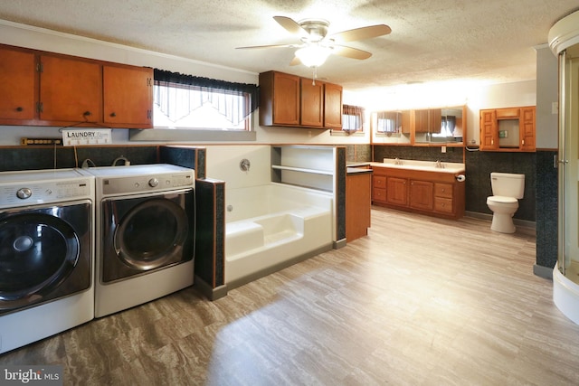 2447 General Potter Hwy, Centre Hall, PA 16828 - laundry room featuring a textured ceiling, ceiling fan, light wood-style flooring, and separate washer and dryer