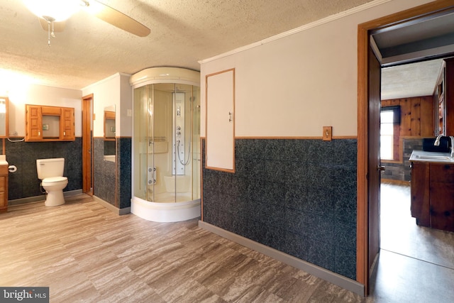 2447 General Potter Hwy, Centre Hall, PA 16828 - bathroom with wainscoting, a ceiling fan, a sink, and a textured ceiling