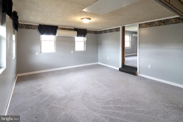 2447 General Potter Hwy, Centre Hall, PA 16828 - spare room featuring a textured ceiling, dark carpet, an AC wall unit, and plenty of natural light