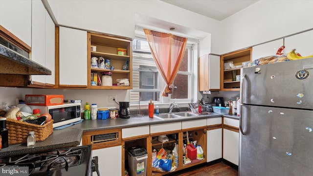 kitchen with open shelves, a sink, freestanding refrigerator, black range with gas stovetop, and white cabinetry