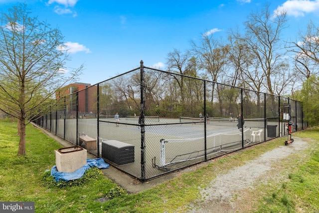 view of sport court featuring fence