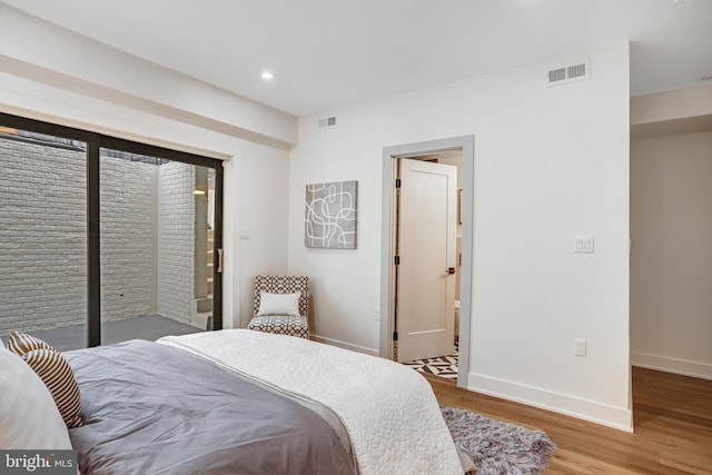 bedroom with wood finished floors, baseboards, visible vents, and recessed lighting