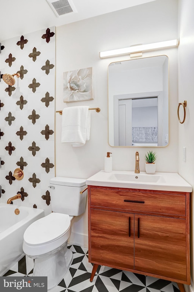 bathroom featuring visible vents, toilet, shower / tub combination, vanity, and tile patterned floors