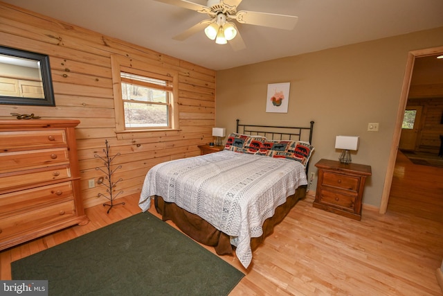 1419 Sandy Shores Rd, Mc Henry, MD 21541 - bedroom featuring a ceiling fan, wood walls, baseboards, and light wood finished floors