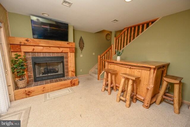 1419 Sandy Shores Rd, Mc Henry, MD 21541 - living room with carpet flooring, visible vents, a tile fireplace, baseboards, and stairway
