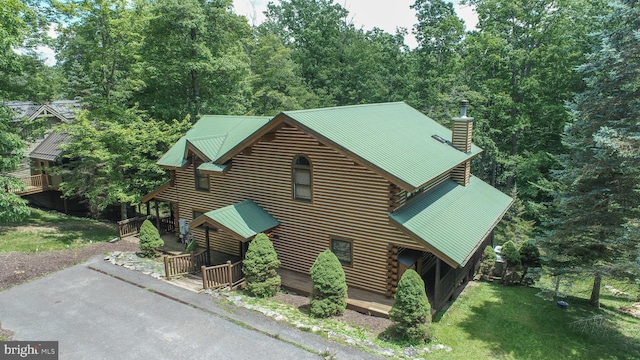 1419 Sandy Shores Rd, Mc Henry, MD 21541 - cabin with metal roof, log siding, a deck, a front yard, and a chimney