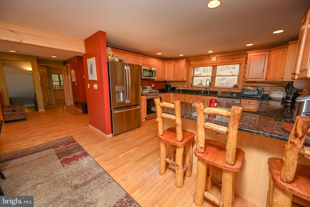 1419 Sandy Shores Rd, Mc Henry, MD 21541 - kitchen with a kitchen breakfast bar, appliances with stainless steel finishes, a peninsula, light wood-type flooring, and recessed lighting