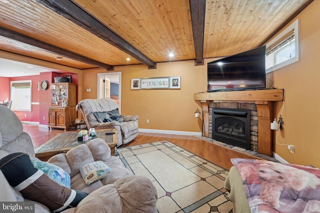 living room with baseboards, plenty of natural light, wood finished floors, and a fireplace