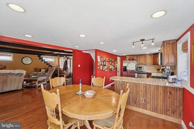 dining room with stairs, wood finished floors, a toaster, baseboards, and recessed lighting