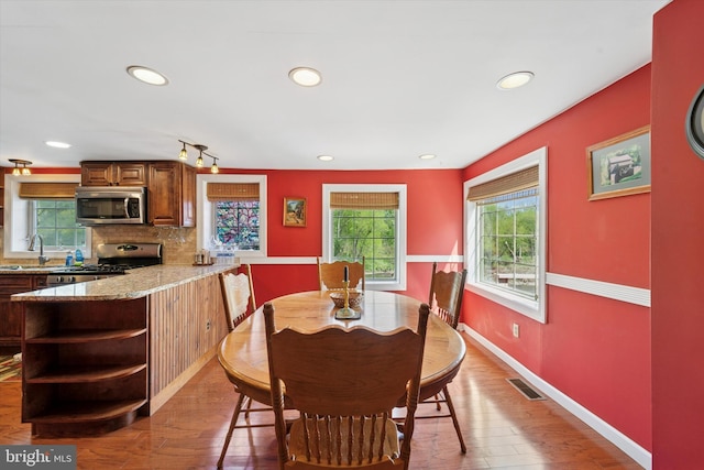 dining room with recessed lighting, wood finished floors, and visible vents