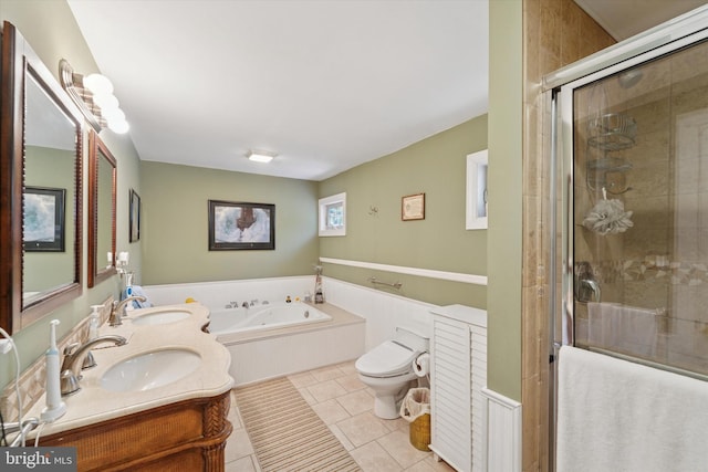bathroom with a garden tub, a shower stall, a sink, tile patterned floors, and toilet