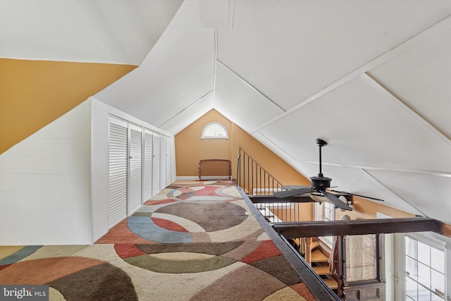 bonus room with vaulted ceiling, carpet, and a ceiling fan