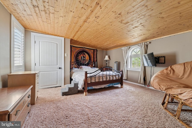 carpeted bedroom with wood ceiling