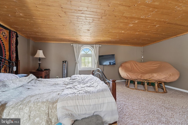 carpeted bedroom with crown molding, wood ceiling, and baseboards