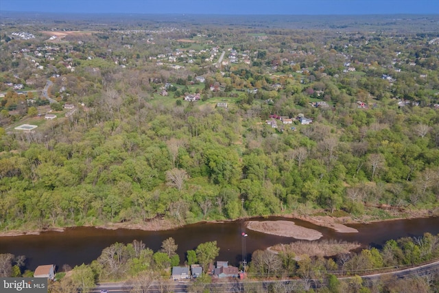 birds eye view of property with a water view and a wooded view