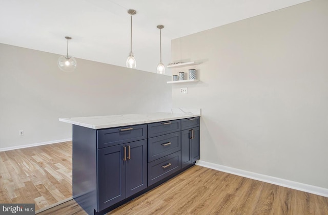 interior space with light wood finished floors, baseboards, and hanging light fixtures