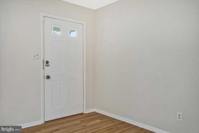 entryway featuring baseboards and light wood finished floors