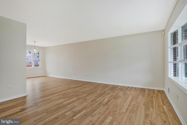empty room with light wood-style floors and baseboards