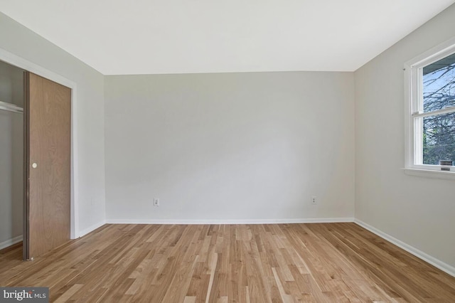 interior space with light wood finished floors and baseboards