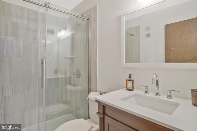 full bath featuring visible vents, toilet, a stall shower, and vanity