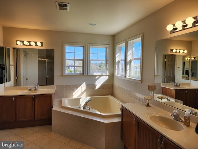 bathroom with tile patterned floors, a sink, and plenty of natural light