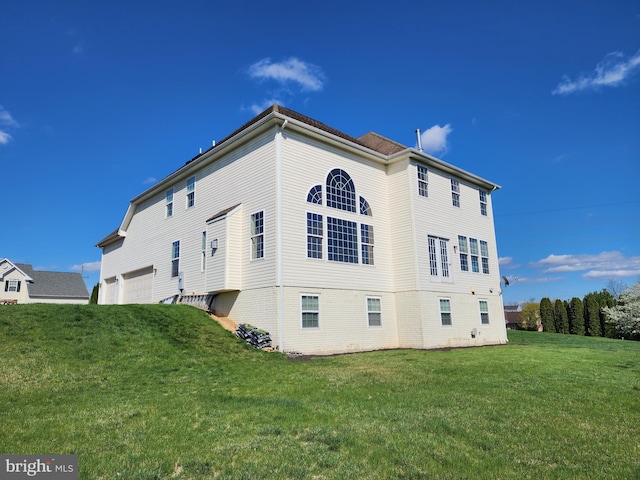 view of side of home with a lawn and brick siding