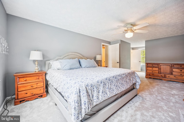 carpeted bedroom with baseboards and ceiling fan