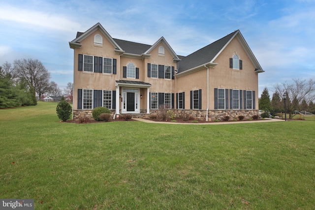 342 Alexander Dr, Telford, PA 18969 - traditional-style house featuring stone siding, a front yard, and stucco siding