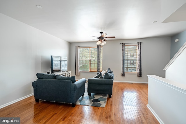 living room with baseboards, ceiling fan, hardwood / wood-style floors, and a wealth of natural light