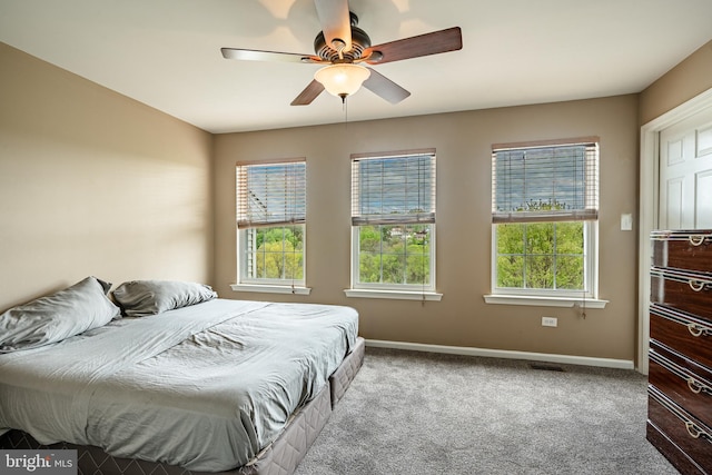 bedroom featuring baseboards, carpet, ceiling fan, and visible vents
