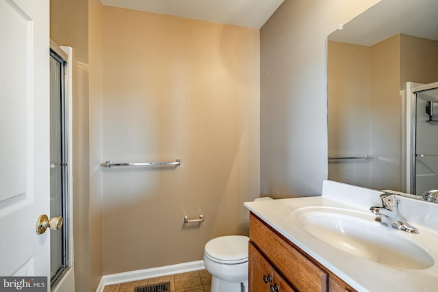bathroom featuring tile patterned flooring, baseboards, an enclosed shower, and toilet