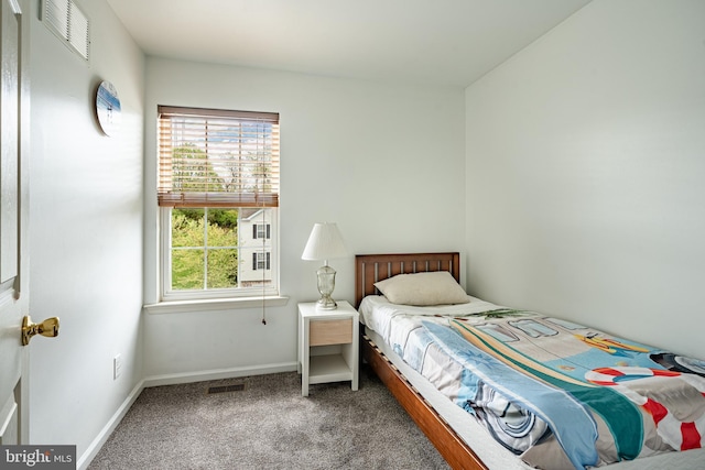 carpeted bedroom featuring visible vents and baseboards