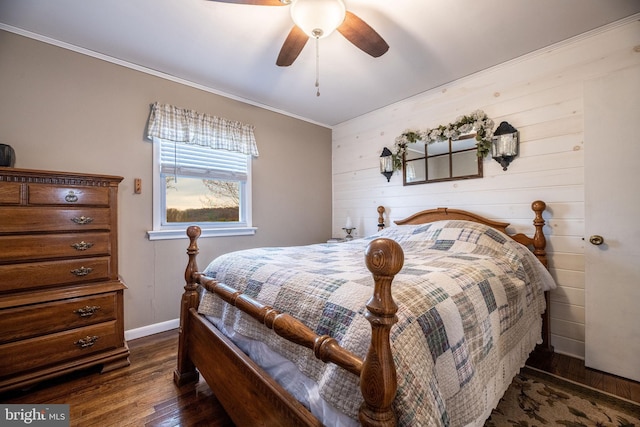 bedroom with crown molding, dark wood-style flooring, baseboards, and a ceiling fan