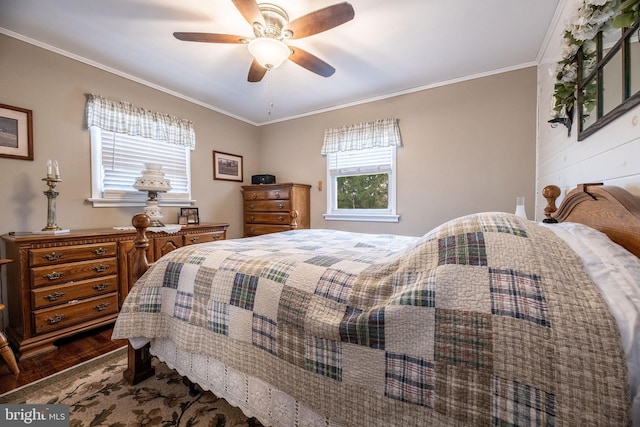 bedroom featuring crown molding, dark wood-style flooring, and a ceiling fan