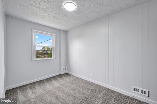 1629 Malvern St, Baltimore, MD 21224 - carpeted spare room with baseboards, a textured ceiling, and visible vents
