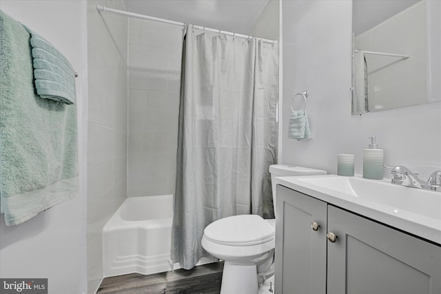 1629 Malvern St, Baltimore, MD 21224 - bathroom with shower / tub combo with curtain, toilet, vanity, and wood finished floors