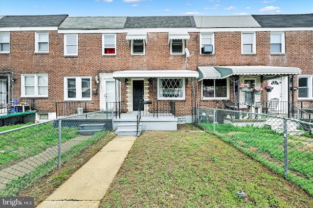 1629 Malvern St, Baltimore, MD 21224 - multi unit property with a front lawn, a fenced front yard, and brick siding