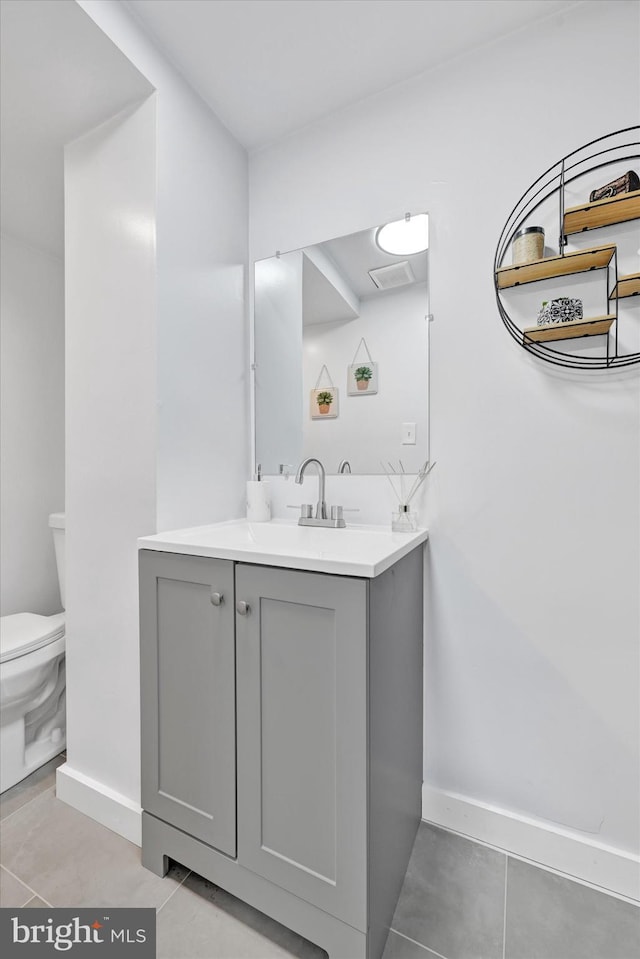 1629 Malvern St, Baltimore, MD 21224 - bathroom with baseboards, toilet, tile patterned floors, and vanity