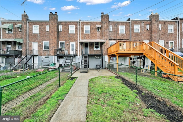 1629 Malvern St, Baltimore, MD 21224 - back of property featuring brick siding, central air condition unit, a fenced backyard, and stairway