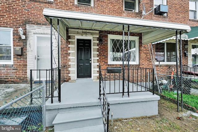 1629 Malvern St, Baltimore, MD 21224 - entrance to property featuring brick siding, fence, and covered porch